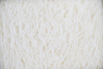 the closeup look of sliced white bread as a food background pattern. a detailed food texture for any creative design.