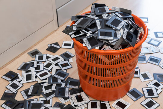 Germany, Wastepaper basket overfilled with bar-coded photographic slides