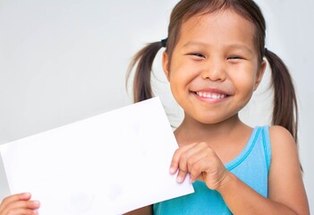 Portrait of a happy little girl holding a blank white sign. Children.