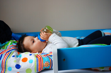 Little boy resting in the bed in the kindergarten