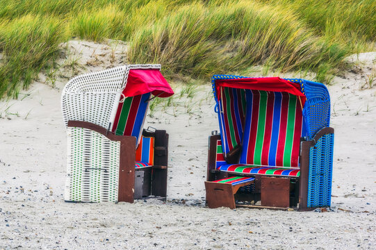 Old fashioned hooded beach chairs on beach
