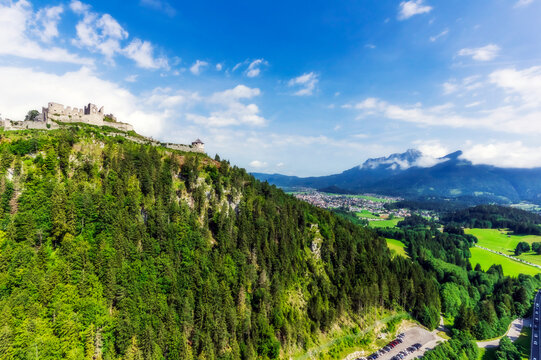 Austria, Tyrol, Reutte, Ruins of Ehrenberg Castle standing on top of forested hill in summer
