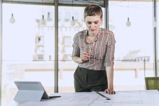 Businesswoman working on plan in office