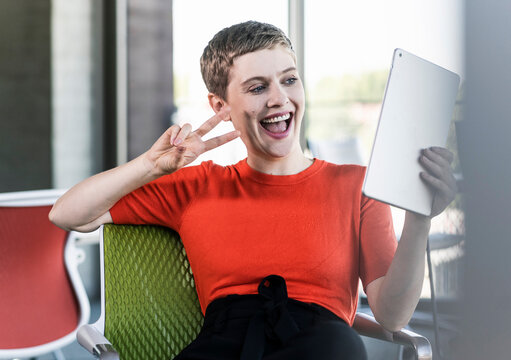 Happy businesswoman using tablet in office