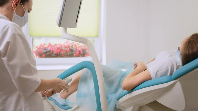 Competent gynecologist with female assistant preparing medical equipment for vaginale check up of woman. Regular diagnostic for health care.