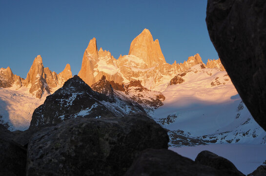 Low angle view of Fitz Roy mountain in orange color at sunrise, Fitz Roy, Argentina