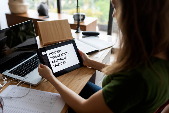 Close-up of businesswoman using digital tablet on desk in home office