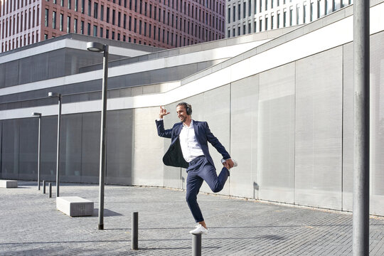 Entrepreneur enjoying music while dancing in city