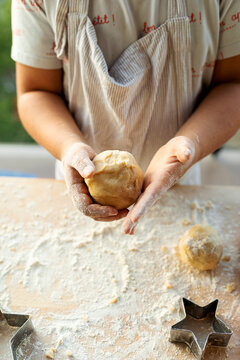 Crop view of boy kneading dough