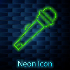 Glowing neon line Microphone icon isolated on brick wall background. On air radio mic microphone. Speaker sign. Vector