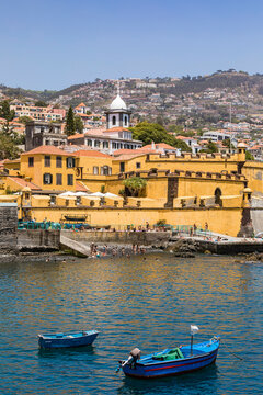 Portugal, Madeira Island, Funchal, View of Forte de Sao Tiago with fishing boats in foreground