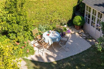 Chairs and table set in springtime backyard