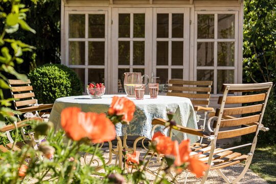 Chairs and table set in springtime backyard