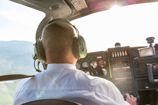 Pilot flying in sports plane, VFR chart on his lap