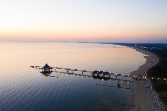 Germany, Usedom, Pier in sea at sunset, aerial view