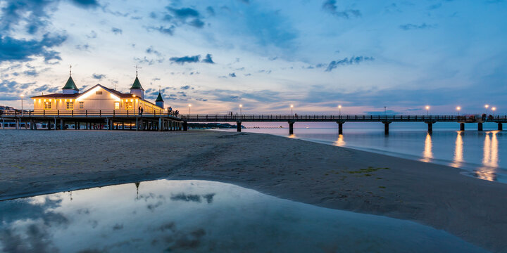 Germany, Mecklenburg-Western Pomerania, Heringsdorf, Illuminated Ahlbeck Pier at dusk