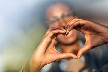 Hands of woman showing heart sign