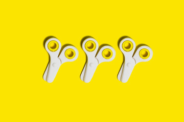 Studio shot of three pairs of school scissors against yellow background
