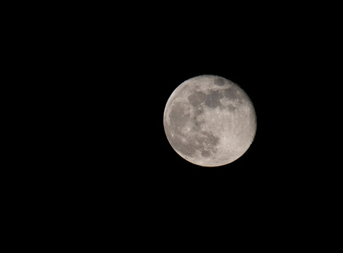 Full moon glowing against night sky