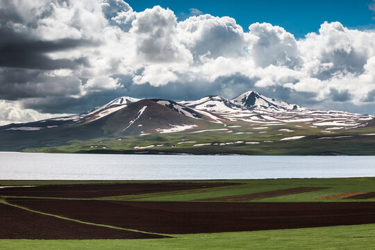 Georgia, Samtskhe-Javakheti, Poka, Large white clouds over alpine lake