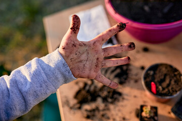 Close-up of boy showing his dirty hand from gardening