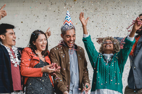 Happy Multiracial People Celebrating With Confetti At Birthday Party - Young Group Of Friends Having Fun Together