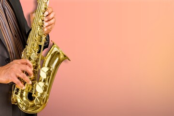 Obraz premium Beautiful golden saxophone on red background,