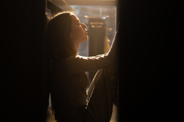 Loneliness Asian woman sitting on the floor with hugging herself. Beautiful female feeling depressed living alone in the dark and think of life problems. Mental health and social issue concept.