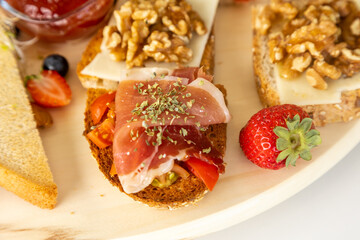 Appetizing assorted bruschetta with various toppings on a wooden table