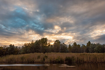 Beautiful landscape with sunset over the lake