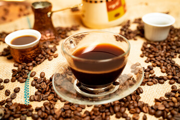 Bunch of different coffee cups and coffee beans on table, closeup shot 