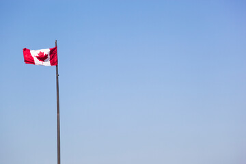 Canadian flag against blue sky