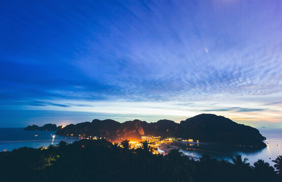 Thailand, Krabi Province, Lights of coastal town lying at foot of coastal hills of Phi Phi Islands