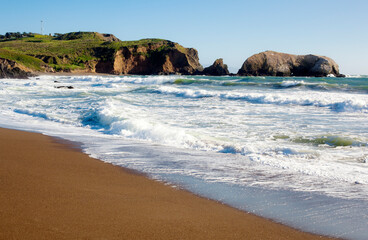 USA, California, San Francisco, Waves brushing sandy coastal beach of Marin Headlands