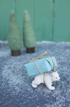 Toy ice bear carrying Christmas tree on back