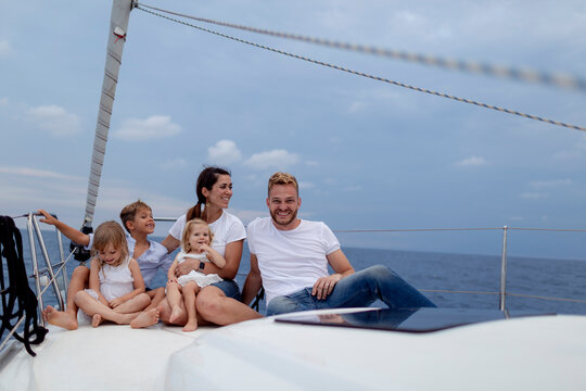 Family sitting on deck during sailing trip