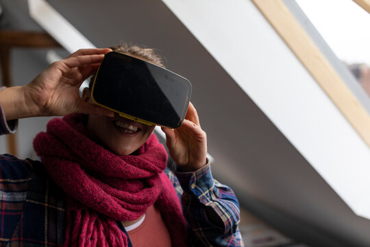 Happy young woman wearing VR glasses