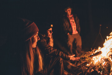 Friends warming up at the campfire