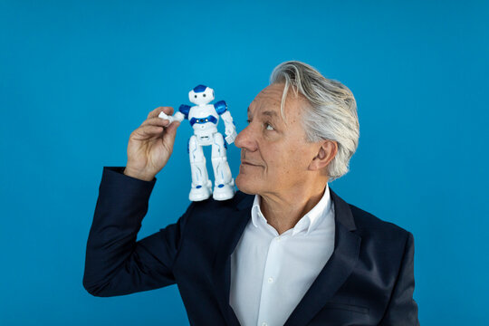 Senior businessman with robot on his shoulder