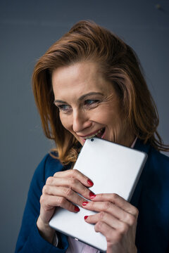 Redheaded businesswoman holding digital tablet