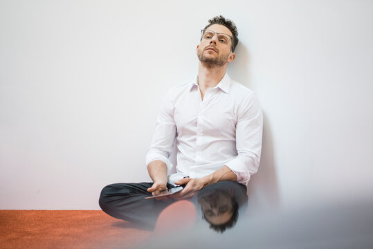 Businessman sitting on the floor having a break