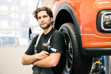 Portrait of a confident car mechanic in a workshop
