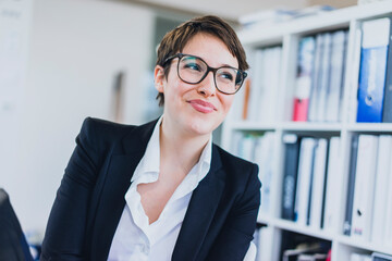 Portait of smiling young businesswoman in office