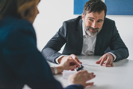 Businessman and businesswoman playing table football in office