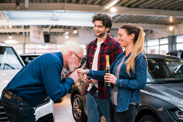 Couple buying new car at car dealership