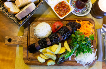 Fototapeta na wymiar Turkish Kebab eggplant and meatballs. Freshly grilled eggplant Kebabs. Middle eastern cuisine
