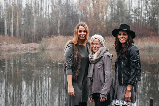 Group picture of three happy friends in autumnal nature