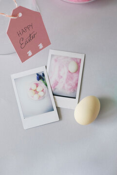 Polaroid pictures of easter eggs on the desk, from above