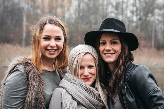 Portrait of three happy friends in autum