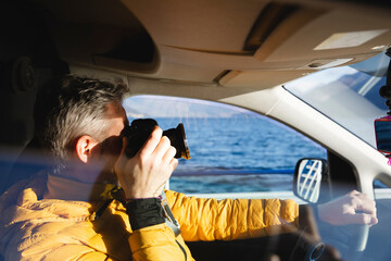 Italy, Como, man taking picture from the car